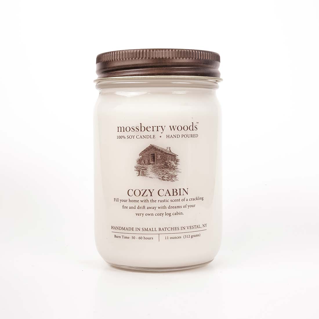 Cozy Cabin Country Cottage Candle in a mason jar with a brown rustic lid on a white background