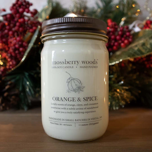 Orange & Spice country cottage candle on a wood table