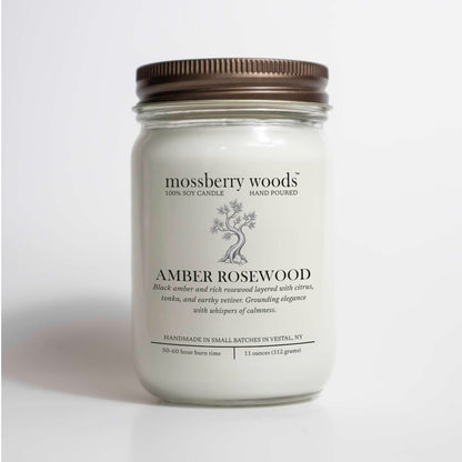 Amber Rosewood scented soy candle in a 12oz mason jar on a white background