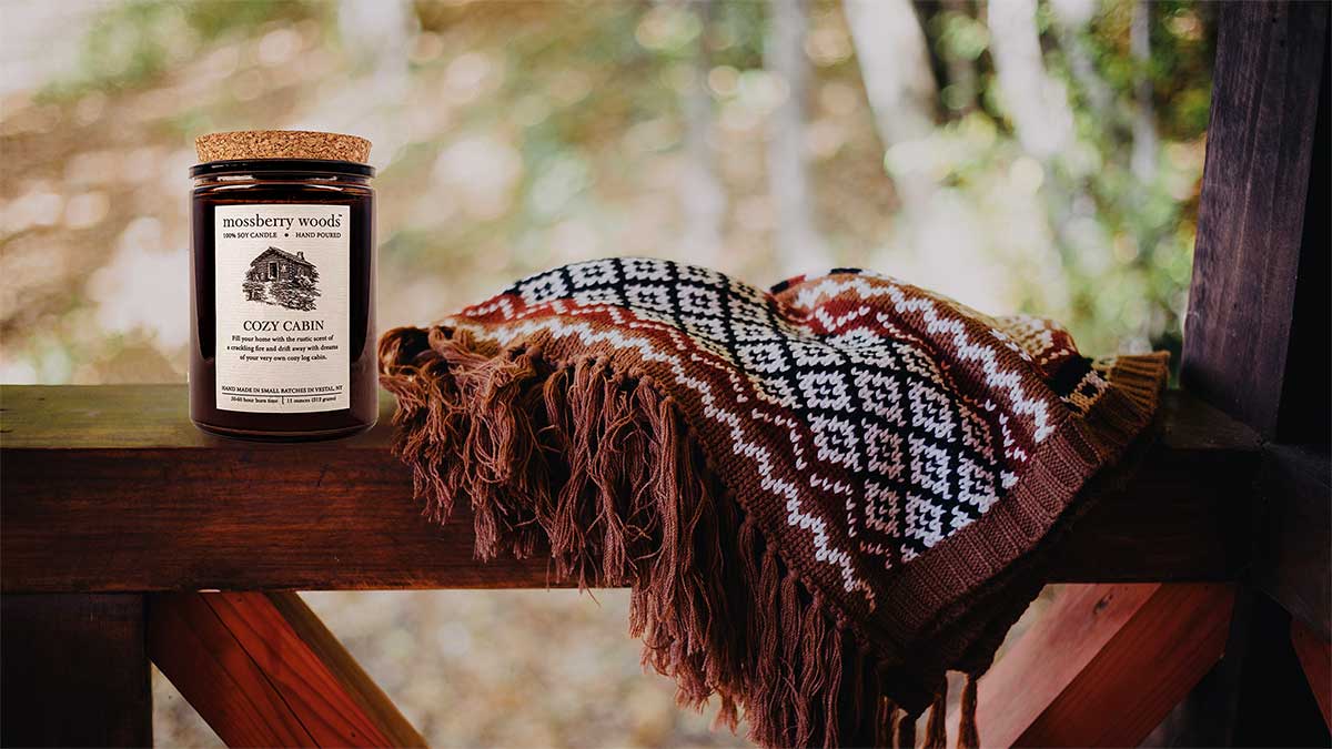 Fall rustic candle on a wooden porch ledge