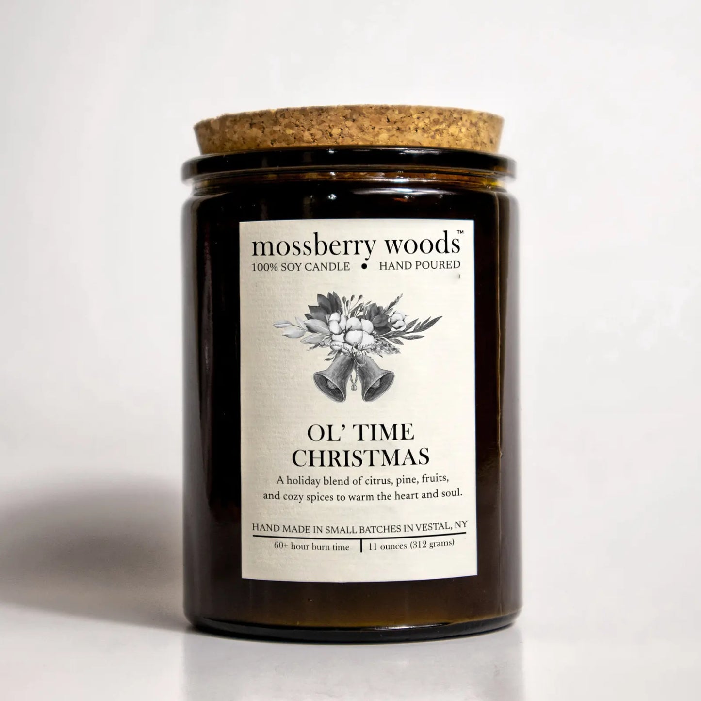 Ol' Time Christmas candle in an amber jar with a cork lid