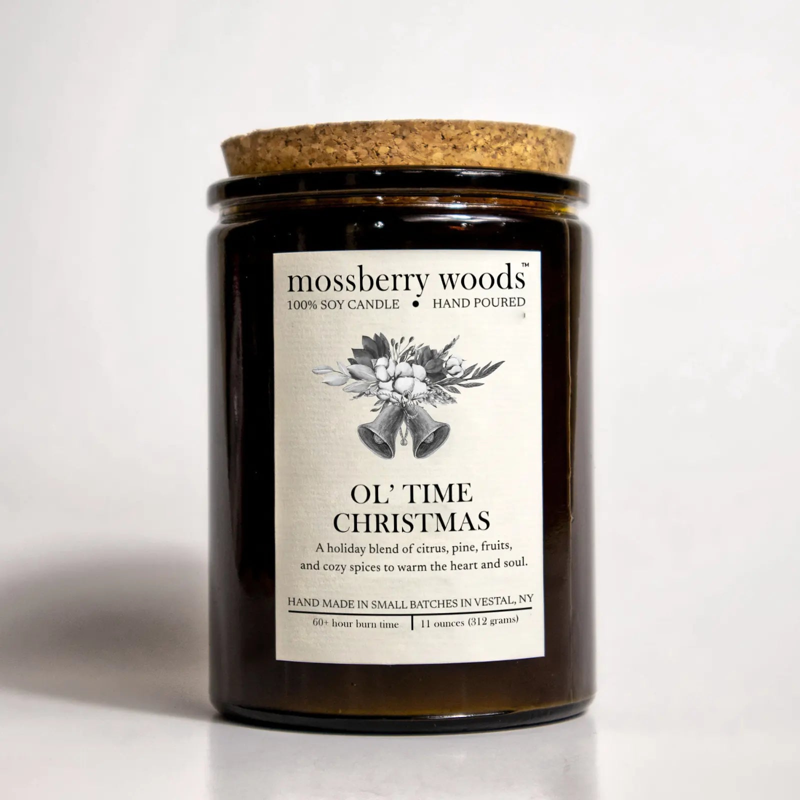 Ol' Time Christmas candle in an amber jar with a cork lid