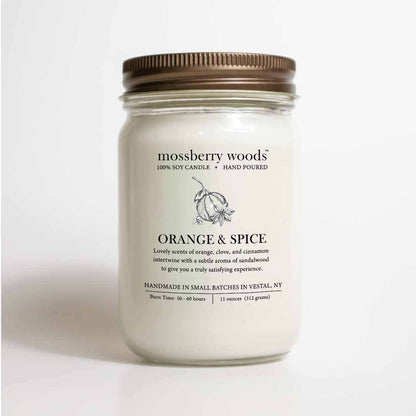 Orange & Spice mason candle jar featuring an illustration of an orange, cloves and cinnamon with a rustic bronze lid on a white background