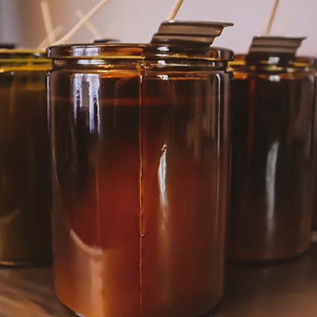 Freshly poured candles curing in their rustic jars