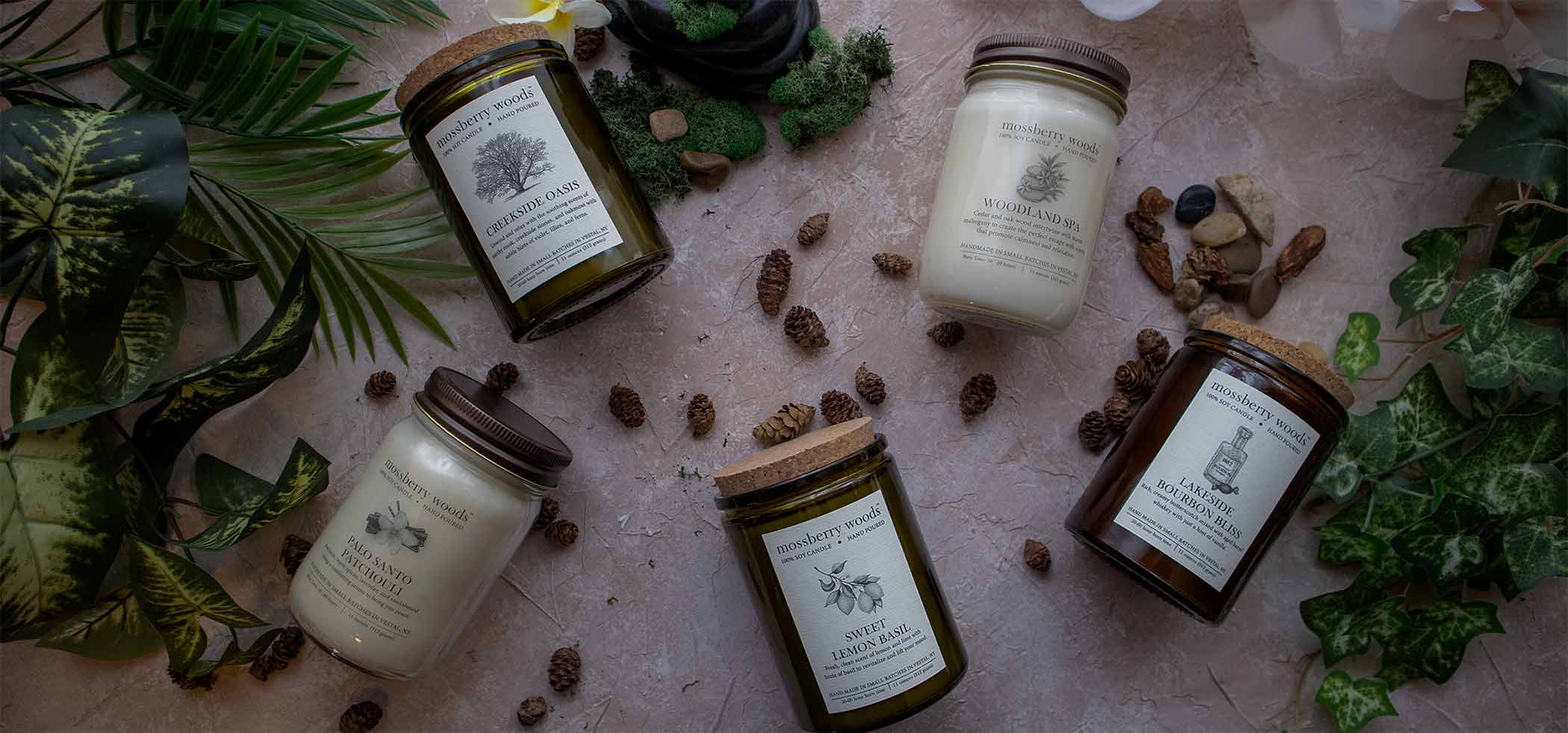 Rustic candles with moss, pine cones, stones, and ivy