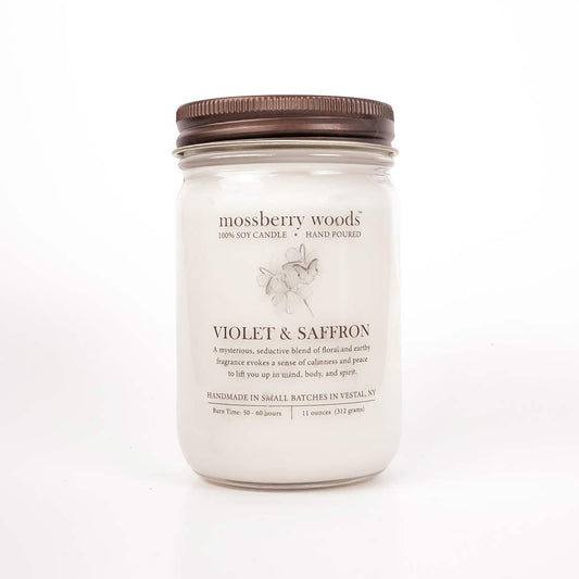 Violet & Saffron Country Cottage candle in a mason jar with rustic brown lid on a white background