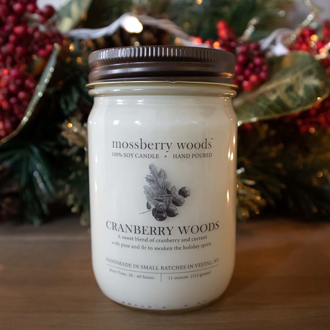 Cranberry Woods country cottage candle on a wood table