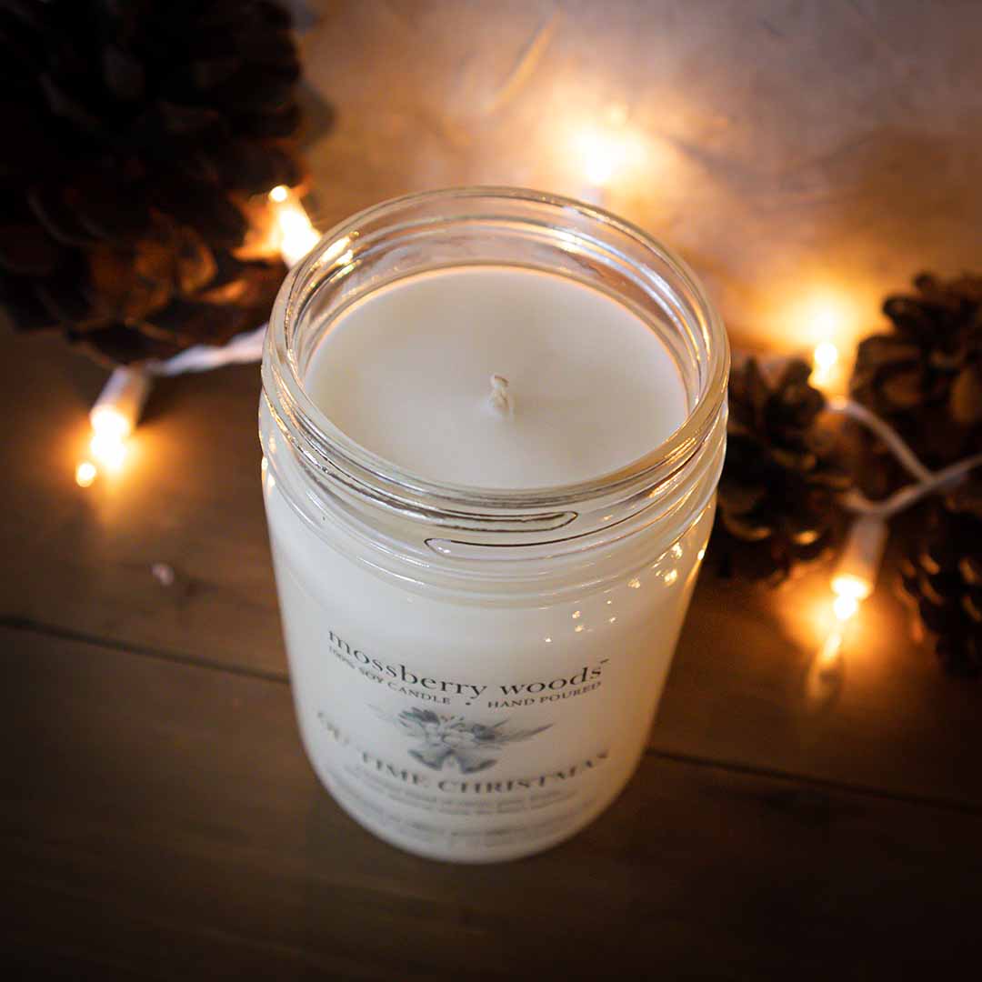 Top view of an Ol' Time Christmas country cottage candle on a wood table