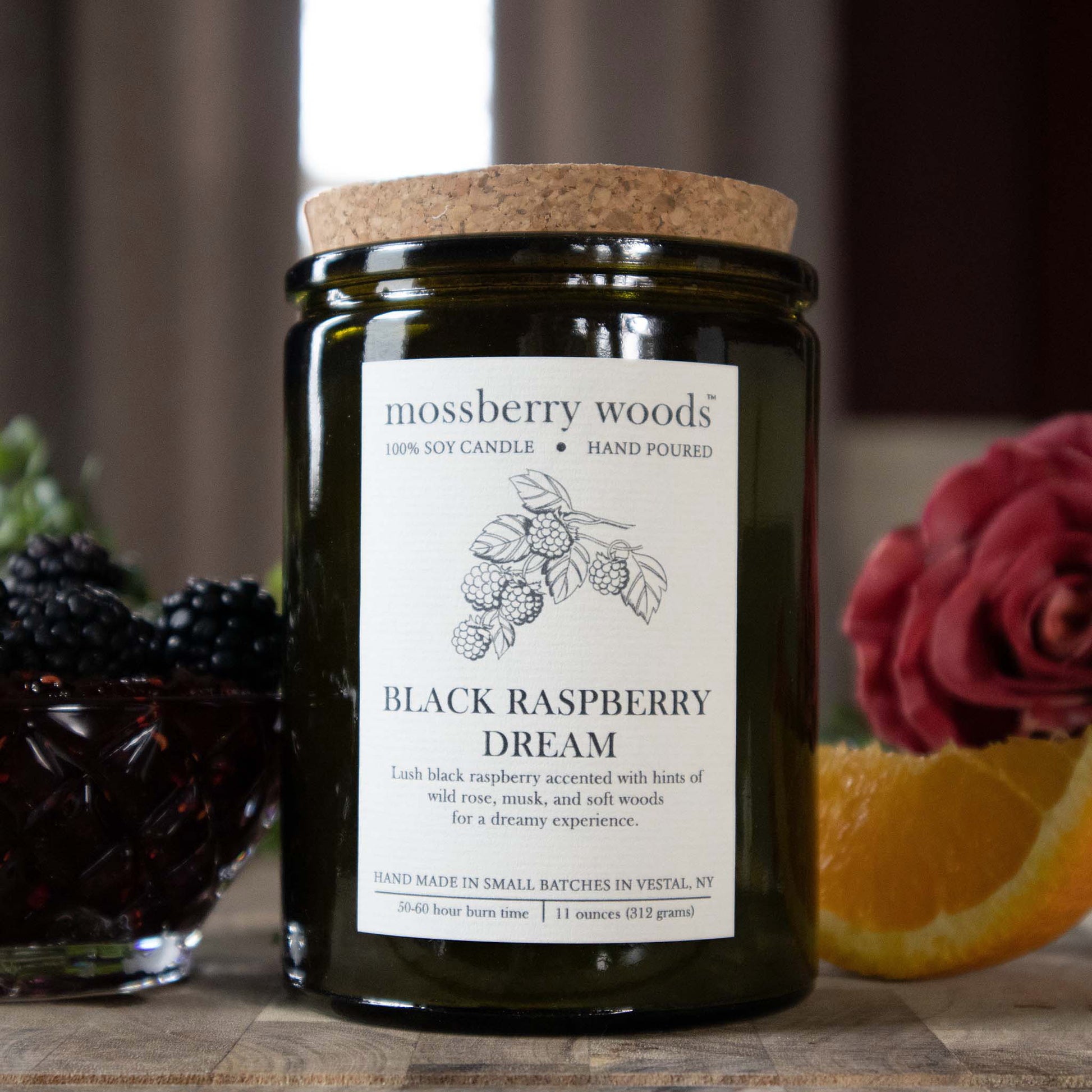 Black Raspberry Dream vintage green rustic candle with a bowl of raspberries in the background